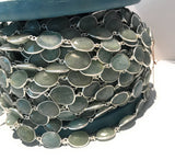 Detailed view of solid sterling-silver bezels surrounding pale blue green faceted Aquamarine stones