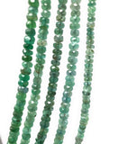 Close up of Zambian Emerald beads showing natural green gemstone color