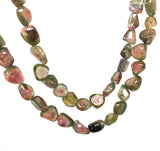 Close up of AAA watermelon tourmaline beads showing natural pink green color zoning and high clarity faceted gemstone details