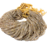 Bunch of Golden Rutilated Quartz beads shown on white background