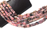 Macro texture of natural pink opal healing crystal nuggets highlighting soft pastel gemstone quality