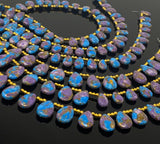 Vibrant blue  and purple gemstone beads with copper-colored matrix arranged in a continuous strand.