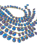Blue and purple copper turquoise teardrop beads with polished surfaces and top-drilled holes.