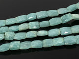 Close up of blue green Amazonite beads with natural gemstone color shown on black background