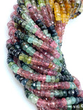 Close-up of natural multi tourmaline faceted beads showing pink, green, yellow and dark color variations