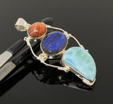 Close up of ocean blue larimar gemstone showing natural wave patterns in sterling silver setting