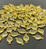 Lemon Topaz jewelry links with loops positioned at opposite ends shown on black background