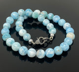 Rare Dominican Larimar beads necklace with elegant diamond clasp shown on black background
