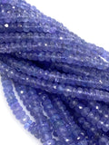 Detailed view of AAA tanzanite gemstone beads showing faceted surfaces and natural blue purple color variations