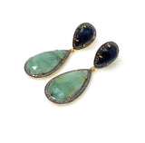 Natural emerald and blue sapphire long earrings photographed at an angle showing two part drop design