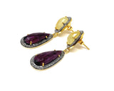 Side View of  yellow sapphires above pear-shaped rose-cut rubies surrounded by small diamonds