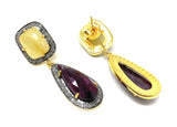 Front and back view of yellow sapphires above pear-shaped rose-cut rubies surrounded by small diamonds