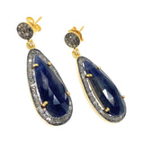 Close-up of natural blue sapphire and pave diamond earrings showing sparkle, gemstone clarity and sterling silver craftsmanship