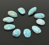 Natural Larimar flat-back cabochons in mixed freeform shapes for jewelry making shown on black background