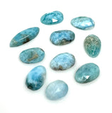 Natural Larimar flat-back cabochons in mixed freeform shapes for jewelry making shown on white background