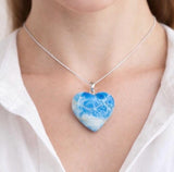 Large larimar heart pendant worn on neck showing statement healing crystal jewelry look