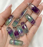 Fluorite gemstone charms held in hand for earring and bracelet making supplies