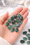 Emerald gemstone charms shown on hand