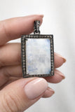 Natural Rainbow Moonstone Pendant shown in hand
