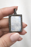 Natural Rainbow Moonstone Pendant shown in hand