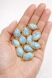 Larimar gemstone connectors shown in hand