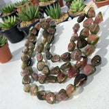 Artistic arrangement of watermelon tourmaline beads displaying vibrant pink green multicolor gemstones for high end jewelry supplies