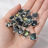 Labradorite gemstone connector held in hand showing sterling silver setting