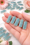 Amazonite gemstone charms held in hand showing natural gemstone jewelry making charm