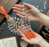 Rose quartz star beads held in hand showing bead size and natural gemstone detail