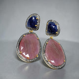 Close-up of blue and salmon sapphire pave diamond earrings showing natural gemstone color contrast and diamond sparkle