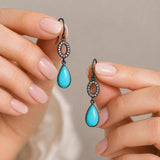 Natural Turquoise and Diamond Earrings held between fingers, Elegant Fine Jewelry for Everyday Luxury