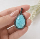 Throat Chakra Larimar pendant featuring genuine Dominican Larimar gemstone and diamonds shown on hand