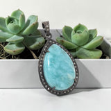 Luxury Larimar jewelry pendant showing detailed craftsmanship and sterling silver setting