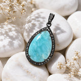 Larimar statement pendant showing ocean blue gemstone patterns and diamond details