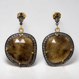 Close up of Natural smoky sapphire earrings with genuine pave diamond accents