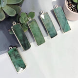 ready-to-use rectangular Emerald jewelry charm photographed on a neutral background