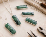 Sterling silver Emerald charm styled as a pendant on a necklace chain