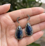 Natural blue sapphire diamond drop earrings in sterling silver shown on hand