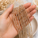 Natural Golden Rutilated Quartz beads shown on womans hand