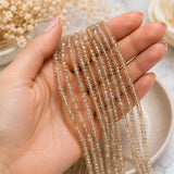 Natural Golden Rutilated Quartz beads shown on womans hand