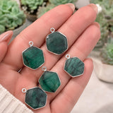 May birthstone Emerald charms for DIY jewelry designs shown on hand