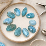 Larimar cabochon lot measuring approximately 11.5 by 7 mm to 19 by 9.5 mm