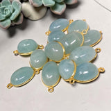 Natural Aquamarine double-loop connectors shown on neutral background