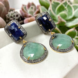 Side view of natural gemstone dangle earrings showing dimensional emerald, sapphire and diamond setting.