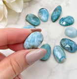 Close-up of Dominican Larimar rose-cut cabochons showing faceted surfaces and natural blue coloration
