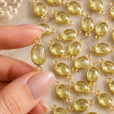 Lemon Topaz jewelry link held in hand