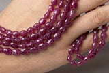 Natural Madagascar Pink Sapphire beads shown on hand