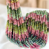 AAA Natural Watermelon Tourmaline faceted gemstone bead strand 3-3.5mm with beautiful pink and green natural colors on a white background.