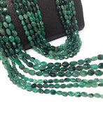Natural emerald smooth oval gemstone beads in rich green color for jewelry making and artisan designs.
