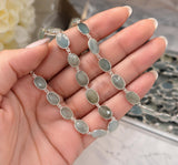 Detailed view of solid sterling-silver bezels surrounding pale blue faceted Aquamarine stones